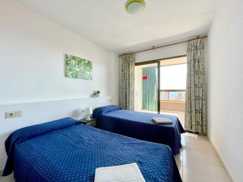 a hotel room with two beds and a window at Apartamentos Paraiso 10 by Gestaltur in Benidorm