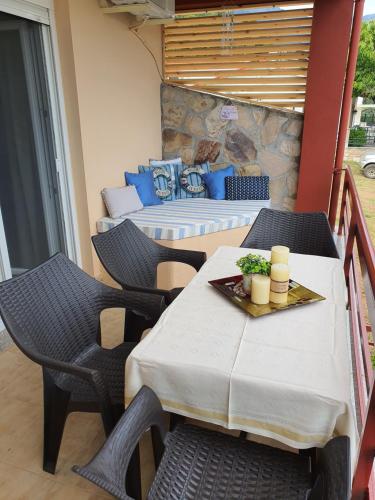 a patio with a table and chairs on a balcony at Antigone View Apartments in Skala Potamias