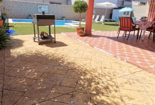 a cat sleeping under a piano on a patio at El Capricho de Espartinas in Espartinas