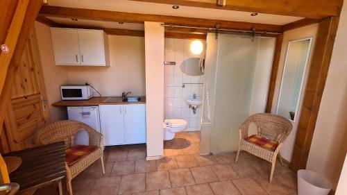 a small kitchen with a sink and a toilet at Ferien- und Erlebnishof Liepe in Liepe