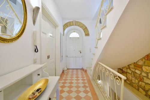 a bathroom with a staircase with a sink and a mirror at Summer By The Sea in Corfu