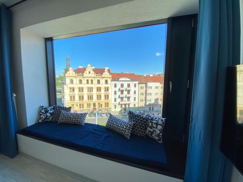 a window seat with a view of a large building at COZY STUDIO WITH GARAGE IN THE CITY CENTER in Plzeň