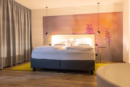 a bedroom with a bed and a bath tub at Hotel Bei Gretel, Wellness & Ayurveda in Struppen-Siedlung