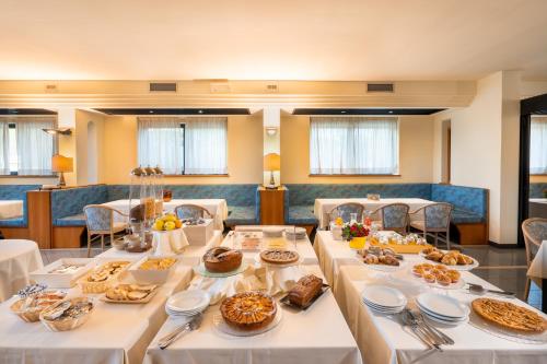 a long table with food on it in a restaurant at Hotel Cristallo di La Rosetta Srl in Assisi