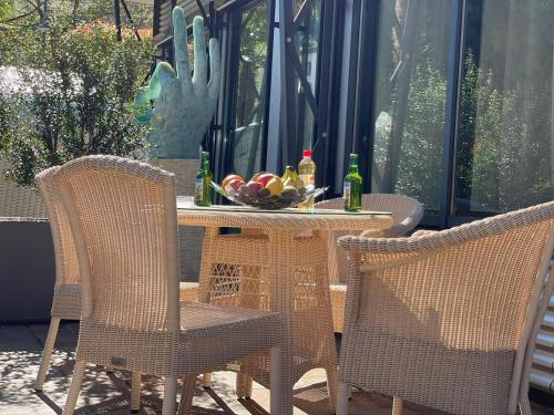 a table and chairs with a bowl of fruit on a patio at Apartments Chalet Wirz Travel in Sarnen