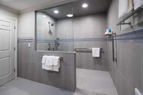 a bathroom with a shower and a sink with towels at Union Bluff Hotel & Meeting House in York Beach