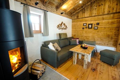 a living room with a couch and a fireplace at Adelheid Keusche - DAS Chalet in Rennweg am Katschberg in Rennweg
