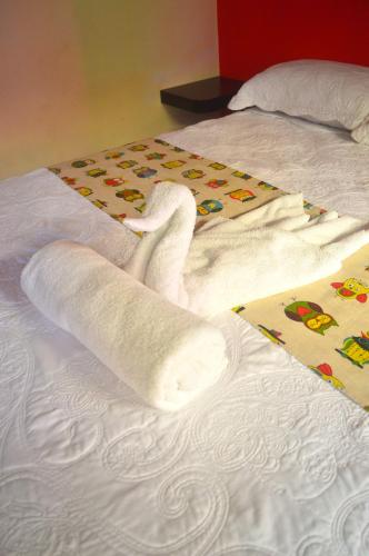 a swan made out of towels on a bed at Millenium Manuel Antonio Park and beach in Manuel Antonio