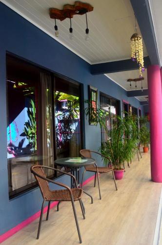 a room with tables and chairs and plants at Millenium Manuel Antonio Park and beach in Manuel Antonio
