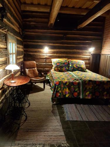 a bedroom with a bed and a table and a chair at Ranta-Keurula in Kärkkäälä