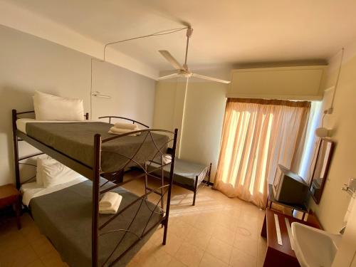 a bedroom with two bunk beds and a window at Artemision in Athens