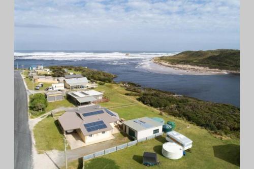 an aerial view of a house with a view of the ocean at ARTHUR RIVER LODGE - DOWN STREAM APARTMENT in Arthur River