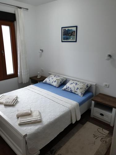 a bedroom with a bed with towels on it at Apartment Marta 2 in Kotor