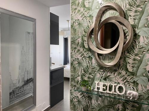 a bathroom with a green leafy wallpaper and a mirror at PLAYA, SOL Y CENTRO HISTORICO in Málaga