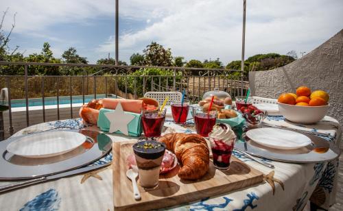 a table with a breakfast of croissants and fruit at Casa Gioia in Giardini Naxos