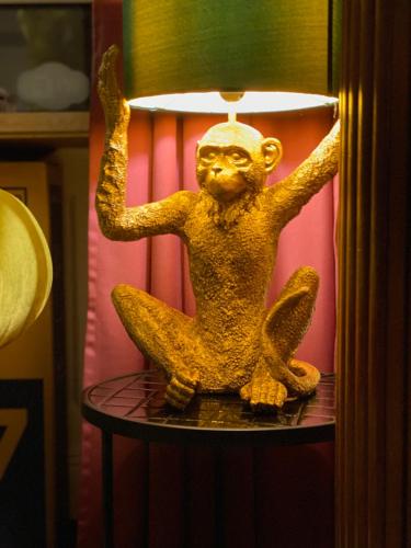 a statue of a monkey sitting on top of a lamp at SmartHotel Mystique Self check-in in Bad Homburg vor der Höhe