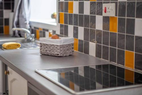 a basket of eggs on a counter in a kitchen at Meadowhead Cottage, Traditional Scottish Cottage in Waterside