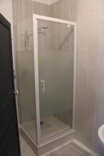 a shower with a glass door in a bathroom at Gîte du fil, Le Lude in Le Lude