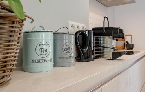 three trash cans sitting on a counter in a kitchen at Quai de l'Ourthe Floor1-2 in La Roche-en-Ardenne