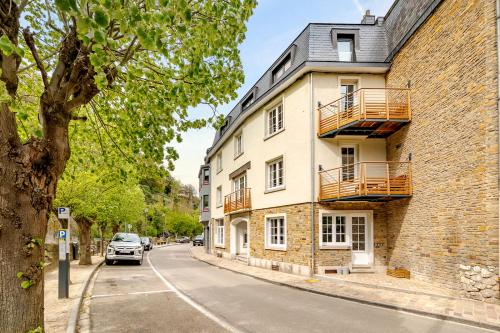 a car parked on a street next to a building at Quai de l'Ourthe Floor1-2 in La Roche-en-Ardenne