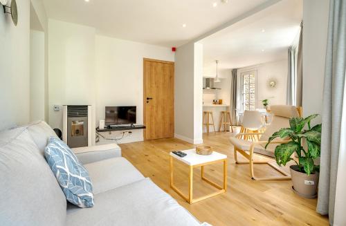 a living room with a white couch and a table at Quai de l'Ourthe Floor1-2 in La Roche-en-Ardenne
