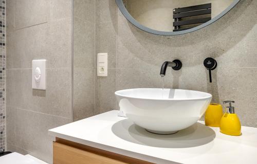 a bathroom with a bowl sink and a mirror at Quai de l'Ourthe Floor1-2 in La Roche-en-Ardenne