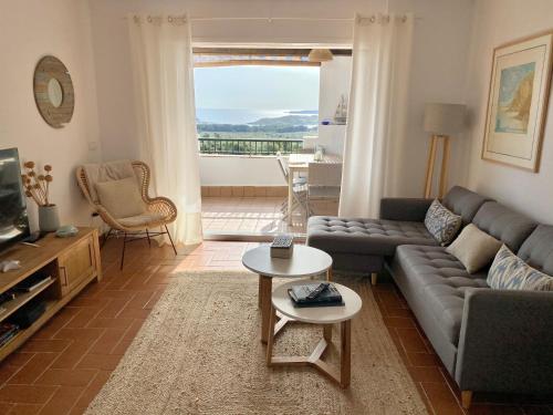 a living room with a couch and a table at La Terraza de la Sabina in Es Mercadal