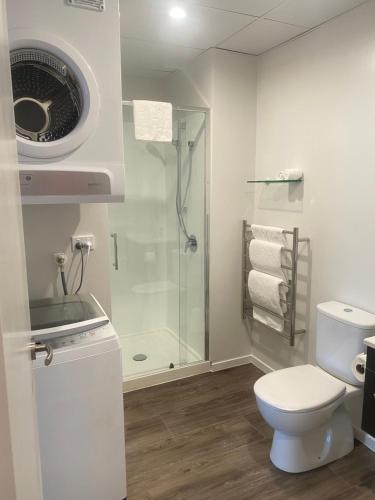 a bathroom with a shower and a toilet and a sink at Ramada by Wyndham Wellington Taranaki Street in Wellington