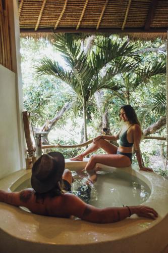 two women are sitting in a bath tub at La Cabane in Jimbaran
