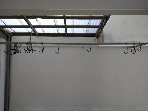 a row of hooks in a room with a window at Cobertura em Caiobá-Matinhos-Pr 2 quadras do mar in Matinhos