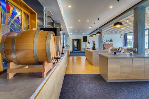 a wine store with a large wooden barrel on a counter at Panorama Ferien Hotel Harz in Güntersberge