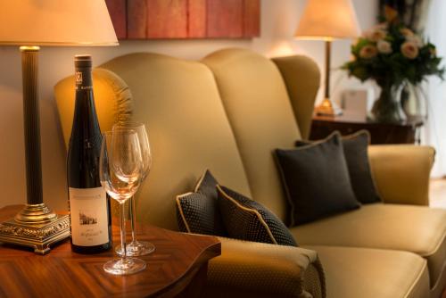 a bottle of wine and a glass on a table at Residence Bellevue in Boppard