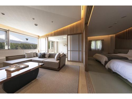 a large bedroom with a bed and a couch at Yukari no Mori in Fujikawaguchiko