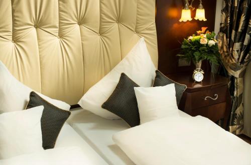 a bedroom with a large white bed with pillows at Residence Bellevue in Boppard