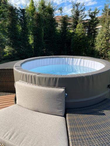 a hot tub sitting on a deck with a chair at DormiVeglia B&B in Monte San Savino