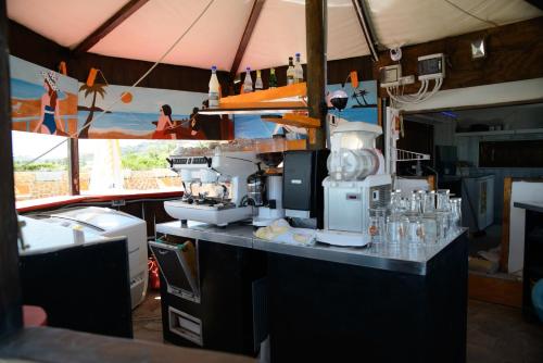 a kitchen with a coffee machine on a counter at Residence Baiadosol in Lido di Fermo