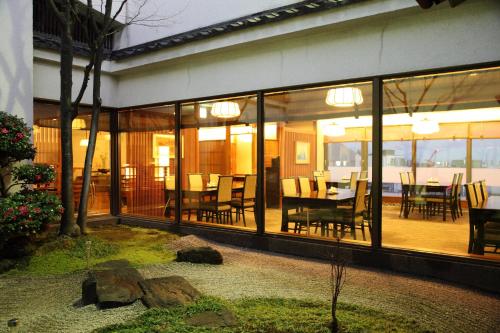 a dining room with glass doors and a table and chairs at ANA Crowne Plaza Fukuoka by IHG in Fukuoka