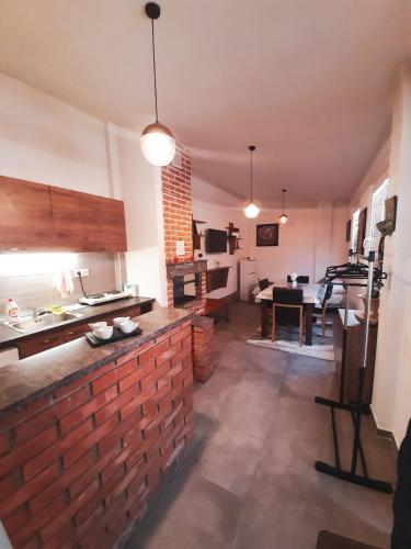 a kitchen with a brick wall and a living room at DS center apartment in Ohrid