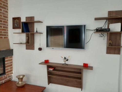 a living room with a tv on a white wall at DS center apartment in Ohrid