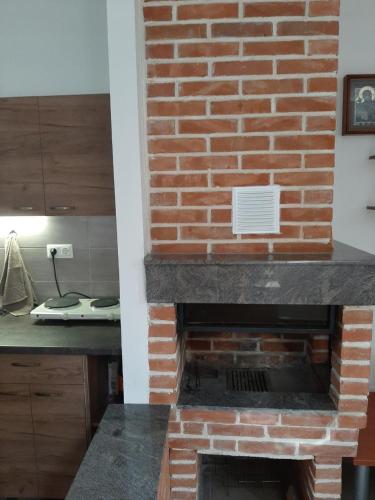 a brick fireplace in a kitchen with a counter at DS center apartment in Ohrid