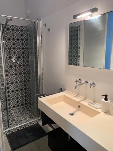 a bathroom with a sink and a shower at Mery's House casa vacanza in Fano
