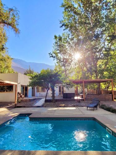 a swimming pool in a yard next to a house at Aldea del Valle - Elqui Villas, Pisco Elqui in Pisco Elqui