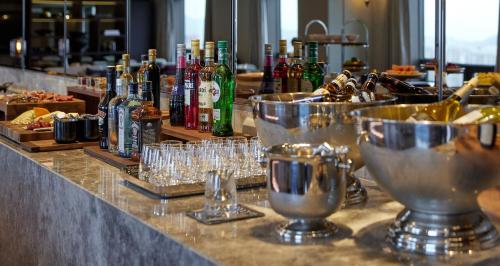 a bar with glasses and bottles of alcohol at Lotte Hotel World in Seoul