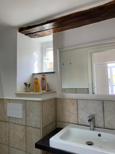 a bathroom with a sink and a mirror at La Casa Del Sole in Vico Equense