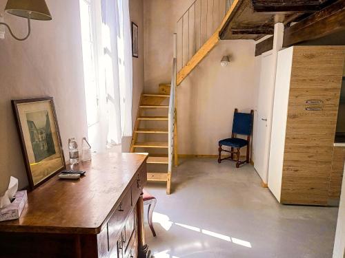 a room with a staircase and a desk and a chair at Relais Real Collegio in Noli