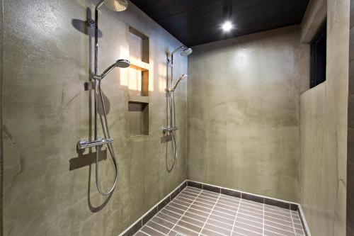 a shower stall in a bathroom with a glass door at Oulu Loft Guesthouse in Oulu