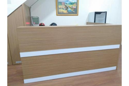 a reception desk in a dental office with wood at RedDoorz @ Komplek MMTC Deli Serdang in Pulauberayan Dadap