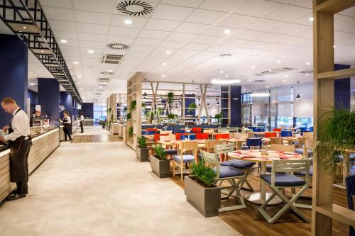a rendering of a restaurant with tables and chairs at Hotel Marina - Liburnia in Mošćenička Draga