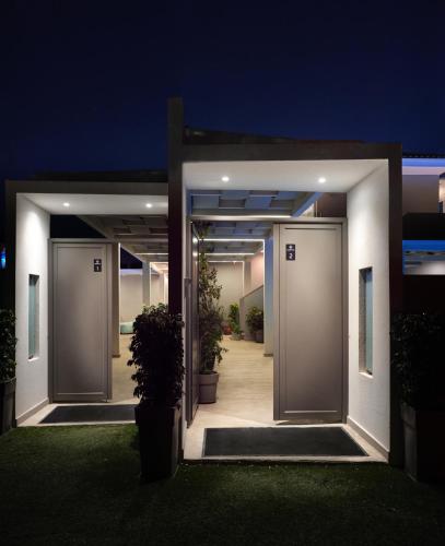 a pair of doors leading into a house at night at Dareia Suites in Plános
