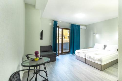 a bedroom with a bed and a table and a chair at Villa Aria in Ohrid